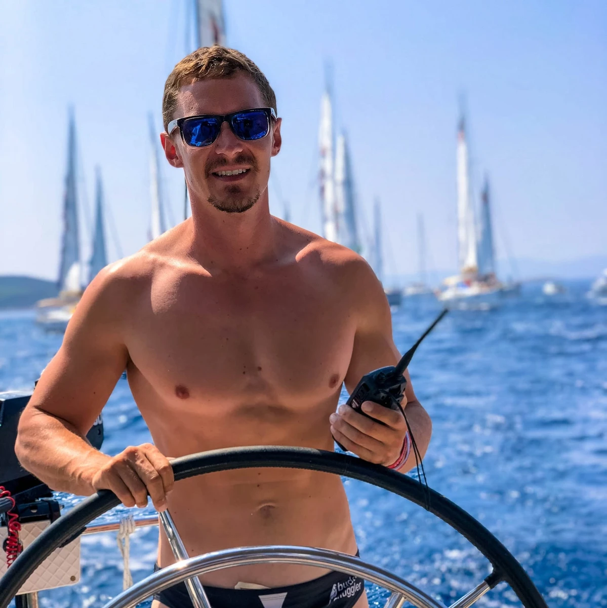 Matt Dawe at the helm of a sailing yacht
